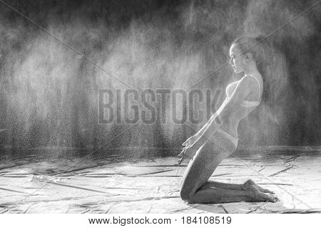 Black and white portrait of young dancer with white flour