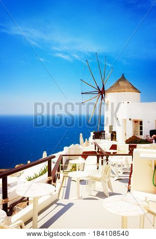 Windmill and blue Aegan sea at Oia, Santorini, Greecer, retro toned