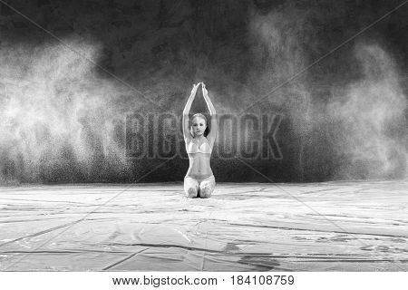 Black and white portrait of young dancer with white flour