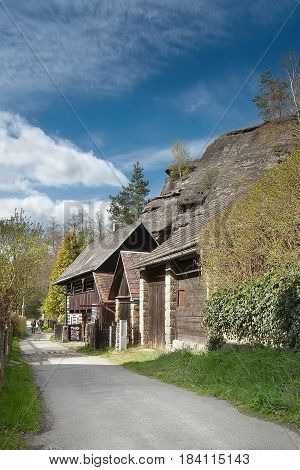 large rock above cottages in village Karba in tourist area Machuv kraj of spring czech landscape