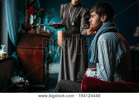 Female painter work with male poseur in art studio