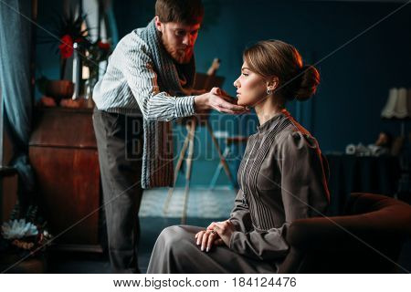 Painter work with female poseur in art studio