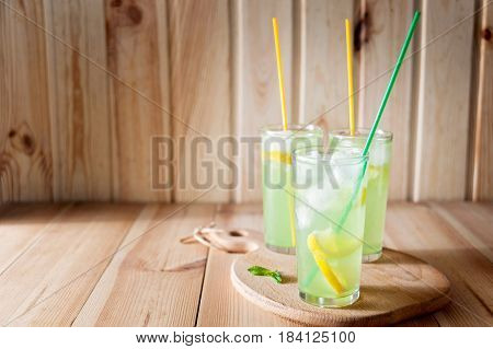 Lemonade In Jar With Fresh Lemon Sliced And Sprig Of Mint