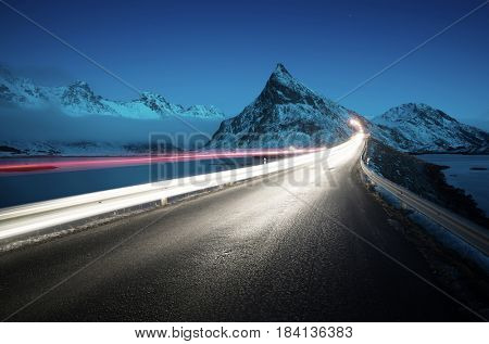 Olstind Mount and car light. Lofoten islands? spring time, Norway