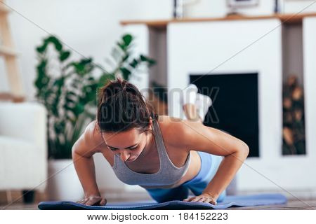 caucasian women exercise indoor at home she is acted push-ups