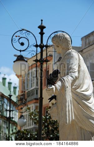 Marble statue with a pigeon on its hand in the Plaza de las Flores Cadiz Cadiz Province Andalusia Spain Western Europe.