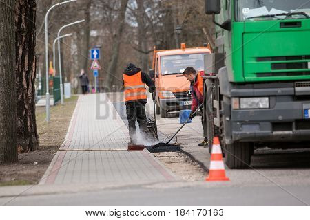 Carnikava, Latvia - April 28, 2017: Workers on a road construction, industry and teamwork.