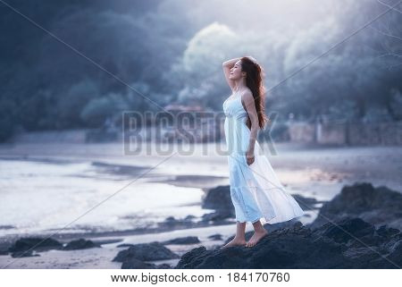 Free happy woman on beach enjoying nature. Natural beauty girl outdoor in freedom enjoyment concept. Mixed race Caucasian Asian girl posing on travel vacation holidays in dress.