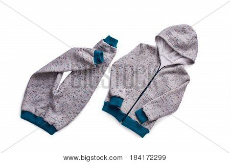 Grey children's sportive costume isolated on the white background. Jacket with hood. Sportive style of children. Concept of the children's fashion industry. Clothes for boys.