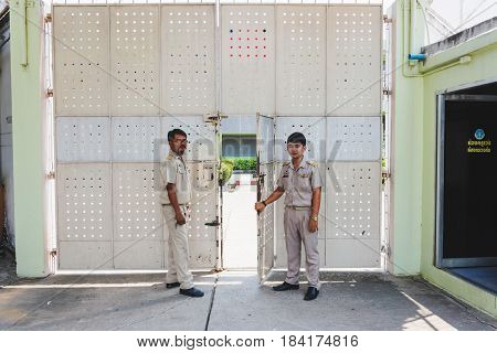 Nakhonsawan Thailand 5 Apirl 2017: prison guard warden in uniform. Standing and opening the dept of corrections Juvenile Detention center's gate.