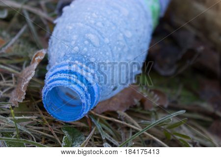 bottle of Water in ice lay on the ground