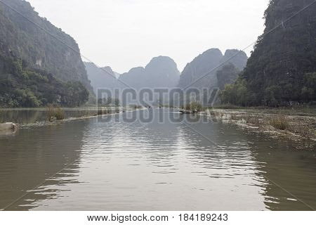 Early morning and fog at Tam Coc - Bich Dong tourist destination near Ninh Binh Vietnam