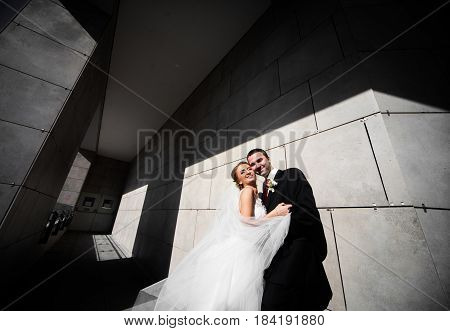 The Happinest  Couple In Love Stand Near Wall