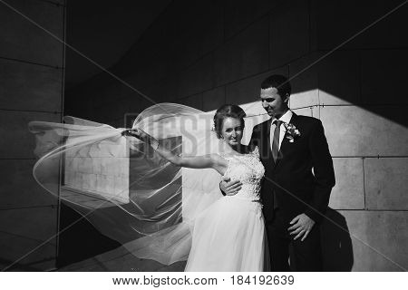 The Happinest  Couple In Love Stand Near Wall