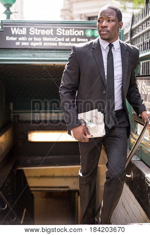 Businessman in full suit at Wall Street subway metro station