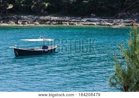 A single boat resting in the sea peacefully