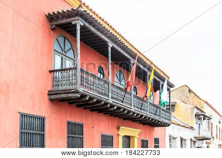 Balcony view with a pink house in the background