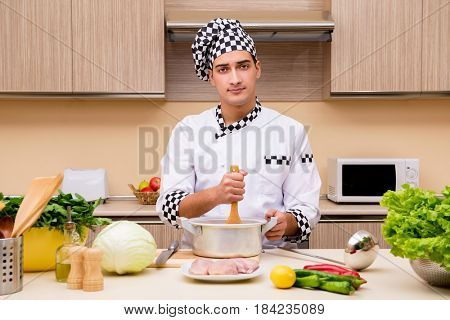Young chef working in the kitchen