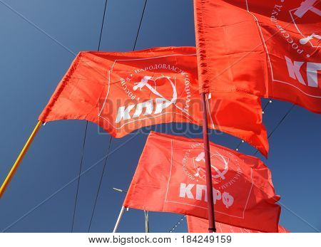 Orel Russia - May 1 2017: May demonstration. Red Communist flags against clear blue sky