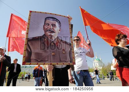Orel Russia - May 1 2017: May demonstration. Young men with Stalin portrait and red Communist flags around