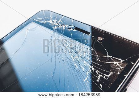 Smartphone or cell pone with broken screen close up