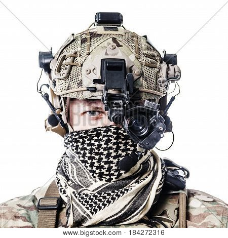 Army Ranger in field Uniforms with weapon, plate carrier and combat helmet are on, his face closed by Shemagh Kufiya scarf. Studio shot