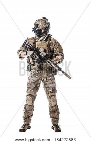 Army Ranger in field Uniforms with weapon, plate carrier and combat helmet are on, his face closed by Shemagh Kufiya scarf. Studio shot