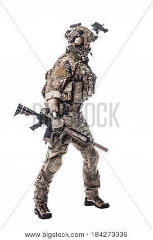 Army Ranger in field Uniforms with weapon, plate carrier and combat helmet are on, his face closed by Shemagh Kufiya scarf. Studio shot
