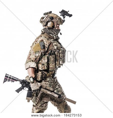 Army Ranger in field Uniforms with weapon, plate carrier and combat helmet are on, his face closed by Shemagh Kufiya scarf. Studio shot