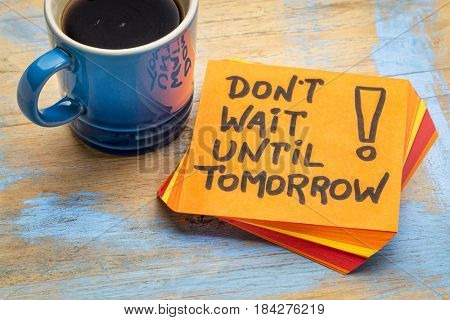 Do not wait until tomorrow - advice or reminder on a sticky note with a cup of coffee