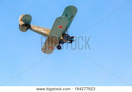 Samara Russia - April 30 2017: Retro Russian aeroplane Polikarpov PO-2 in the blue sky. Text in russian: For friends of fight