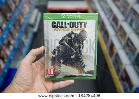 Bratislava, Slovakia, circa april 2017: Man holding Call of Duty Advanced Warfare videogame on Microsoft XBOX One console in store