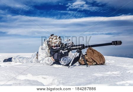 Army soldier with Sniper rifle in action in the Arctic. He lies in the snow desert, suffering from extreme cold, but waiting as long as enemies appear to kill them