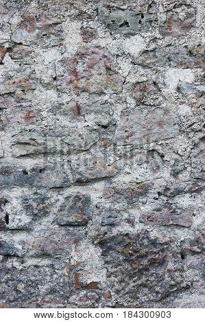 Stone wall background closeup vertical plastered grunge red grey beige stonewall limestone pattern old aged weathered gray lime plaster texture natural grungy textured reddish vintage rough rustic bricks birckwork