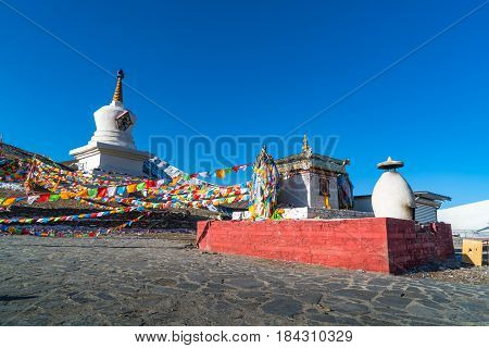 Stupa and prayer flags at the Zheduo Shan Pass Kangding Sichuan China