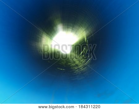 An abstract view of a light at the end of a tunnel. In this case, a very, very long main water line.
