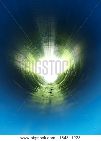 A vertical view of the abstract design created by the light at the end of a long and seamless main water line.