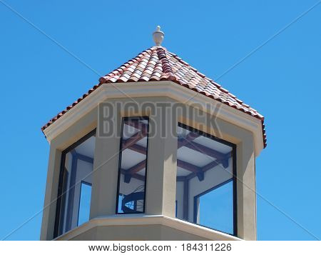 A copula with red tile, architectural carving and lattice beams laid out on the ceiling . Extensive work to create something different in the world of architectural elements.