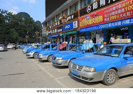 YANGSHOU CHINA - NOVEMBER 18, 2016: Taxis wait for passengers in Yangshou town.