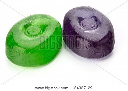 Two colorful fruit hard sugar candies,  boiled sweeties or sugar plums isolated on white background cutout