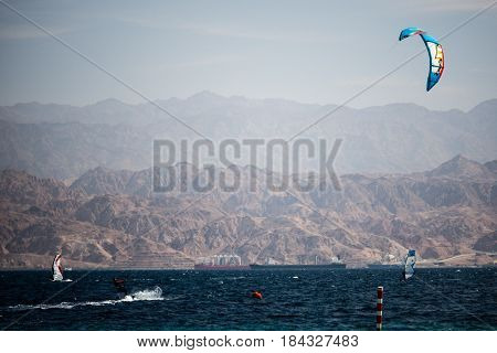 kiter in the surrounding of turquoise sea kiting Israel