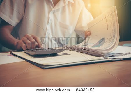 Business analysis - calculator sheet graphs (business report) and analyst hand