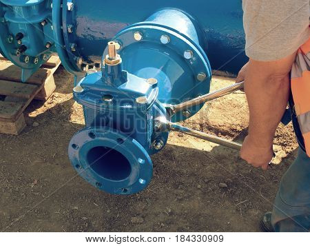 Worker Hands Screwing Gate Valve With Nuts On Piping.