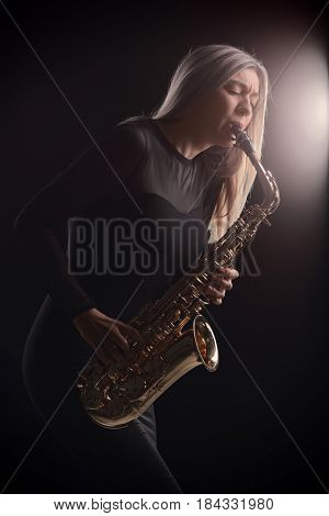 Female jazz musician playing a saxophone during a concert
