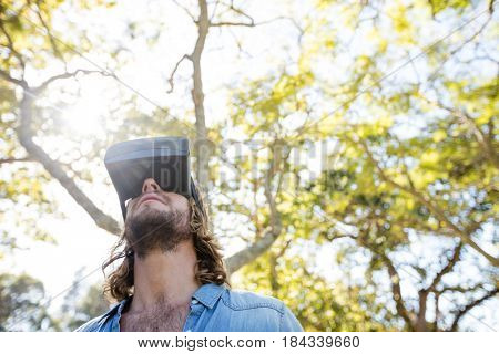 Man using virtual reality glasses in park