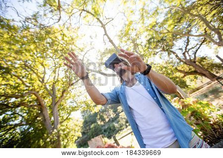 Man using virtual reality glasses in park