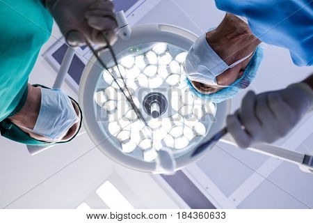 Surgeons interacting while performing operation in operation theater of hospital