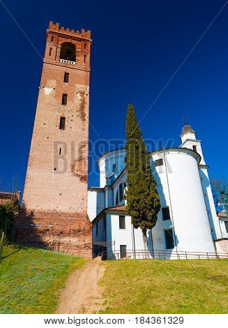 Castelfranco Veneto - February 2017, province of Treviso, Italy: Wide angle view of Catholic church and the old bell tower in Castelfranco, walled town in Northern Italy, sunny day with clear blue sky