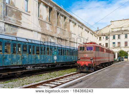 Trieste - March 2016, Italy: Electric locomotive and old train cars in Railroad Museum (Museo Ferroviario di Trieste), one of the landmarks in the capital of Friuli Venezia Giulia region