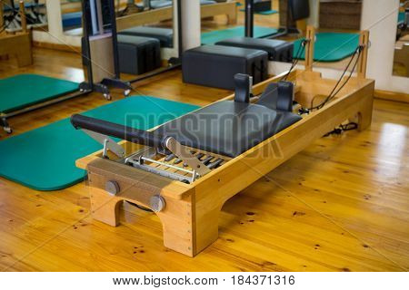 Reformer on wooden floor in gym